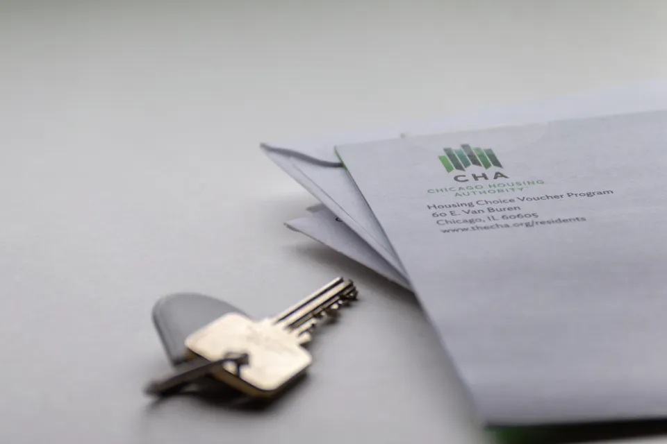 Close-up of house key on table and corner of envelope from Chicago Housing Authority